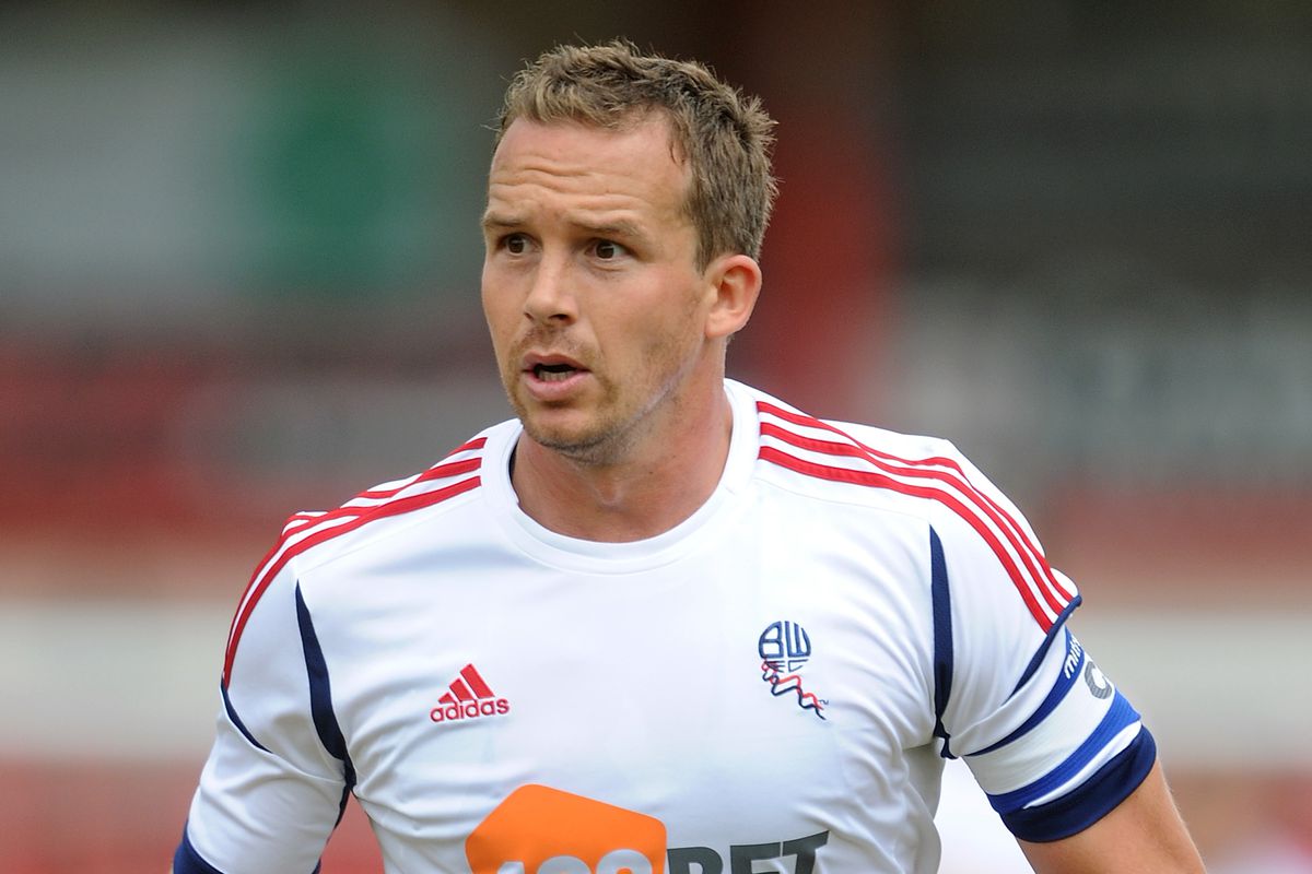 Why was footballer Kevin Davies known as such a physical player? Understanding his tough tackling style.