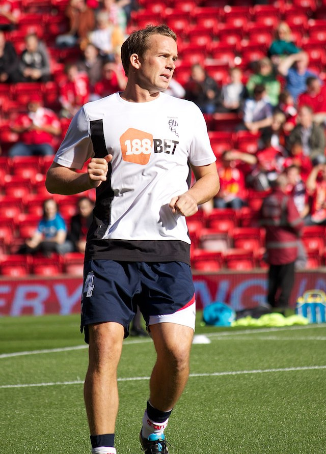 Why was footballer Kevin Davies known as such a physical player? Understanding his tough tackling style.